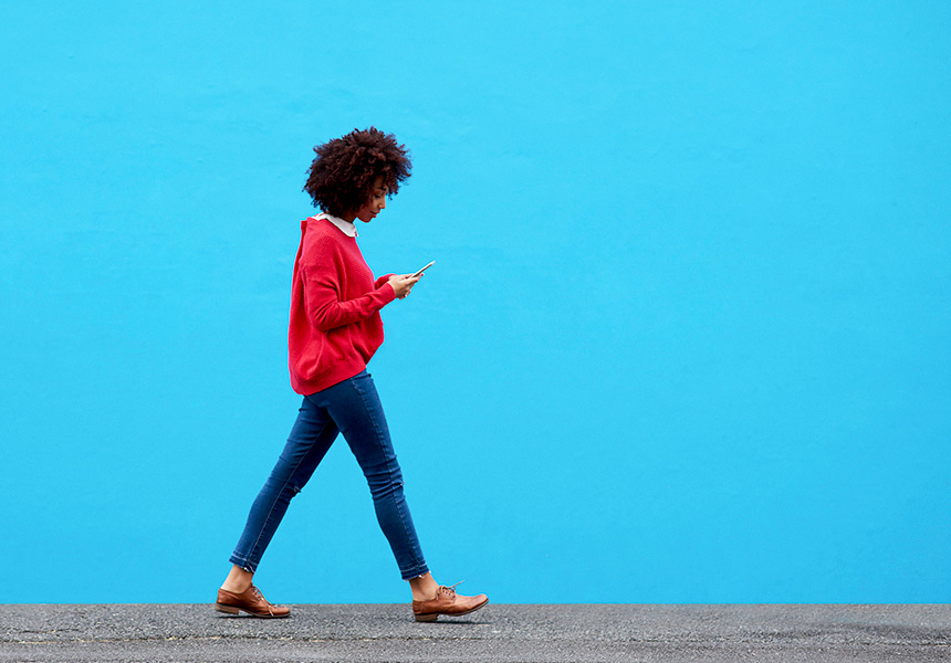 woman walking with phone in hand