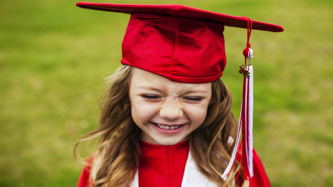 girl wearing red graduation cap and gown