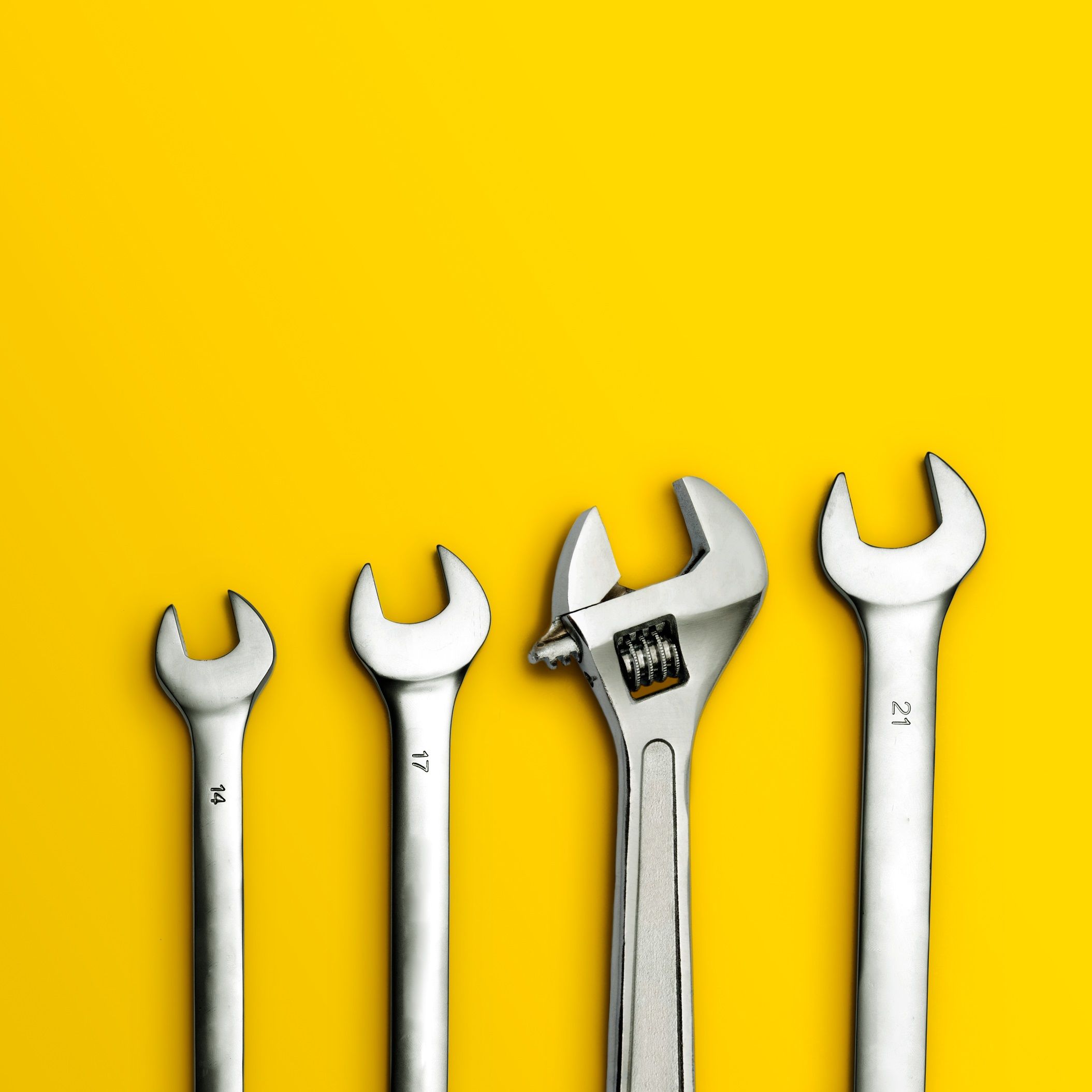 wrenches on yellow background