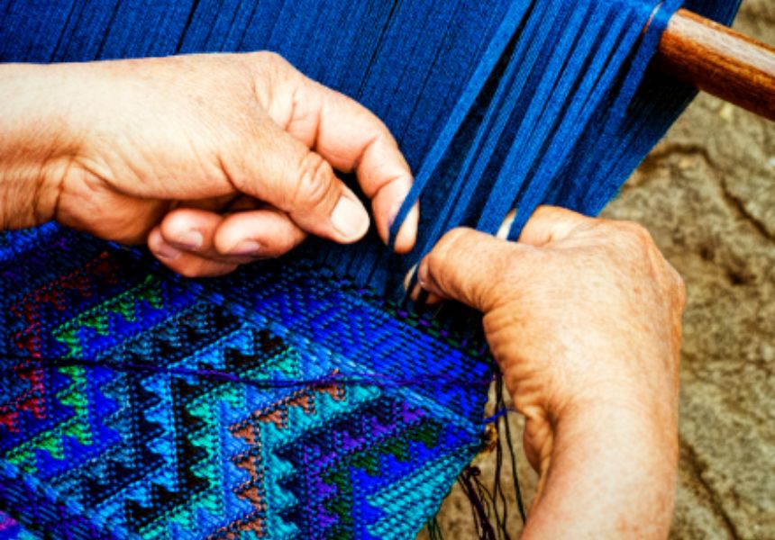 Man knitting blue rug