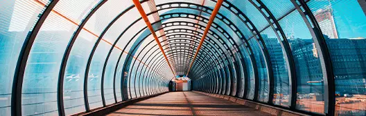 glass tunnel leading to a building