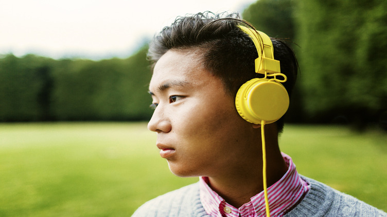 boy wearing yellow headphone