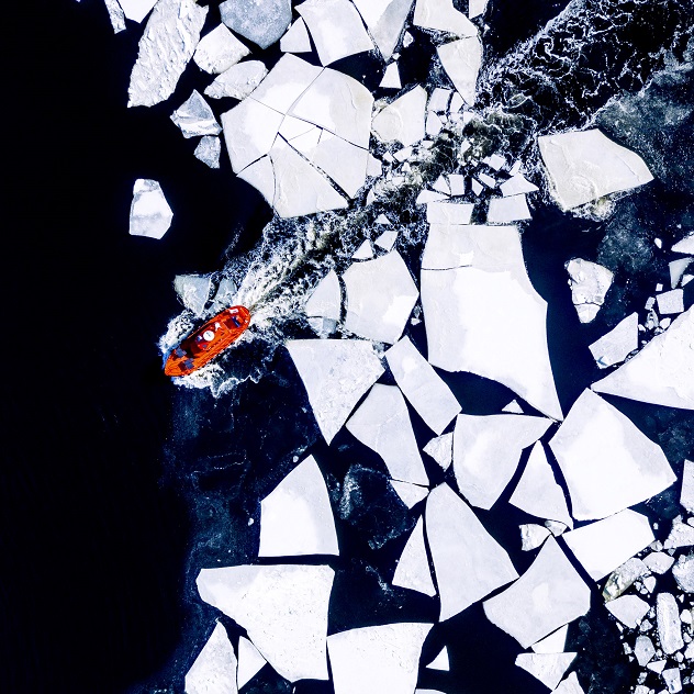 Icebreaker boat navigating through icebergs.