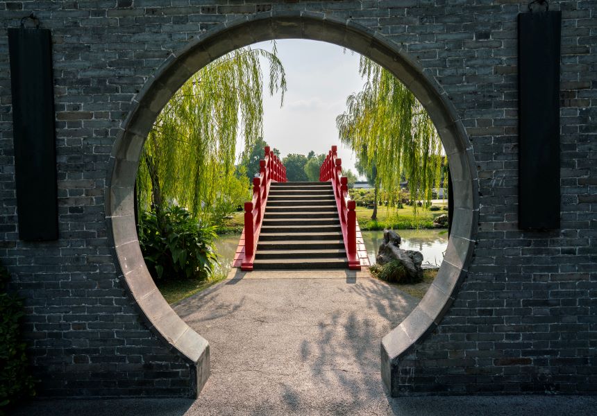 Chinese garden arch leading to bridge