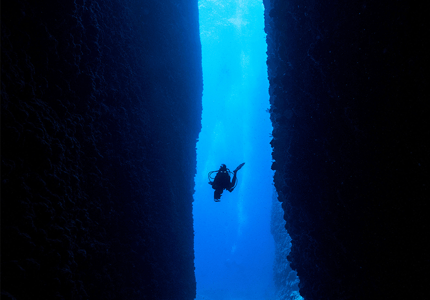 A scuba diver in deep blue waters