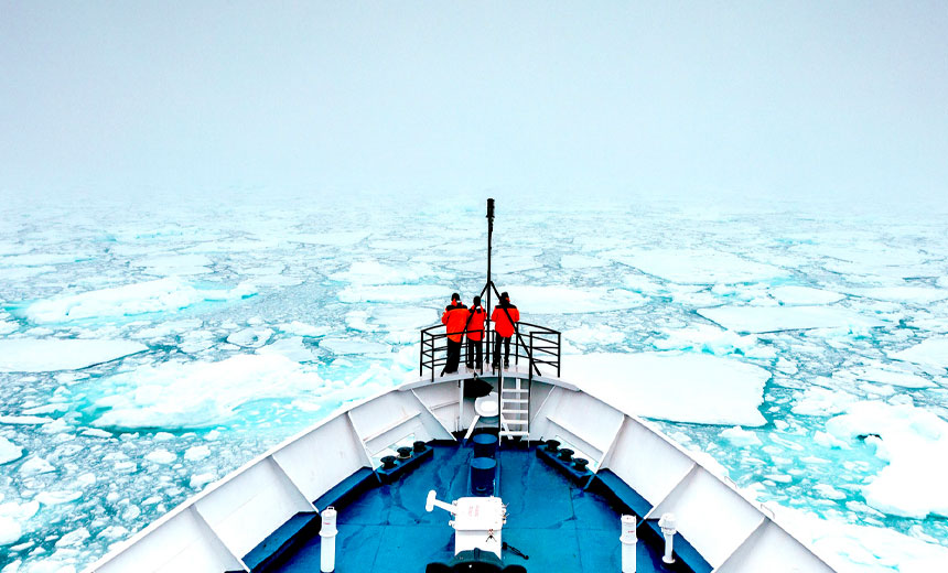 Ship navigates path through broken ice at sea