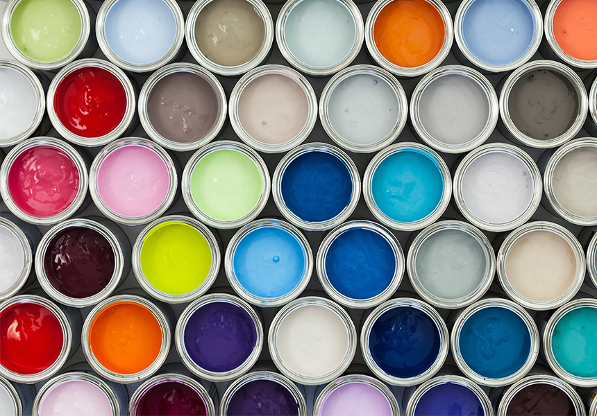 An array of open paint cans with different colors of paint.