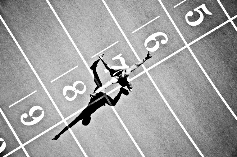 man sprinting towards finish line