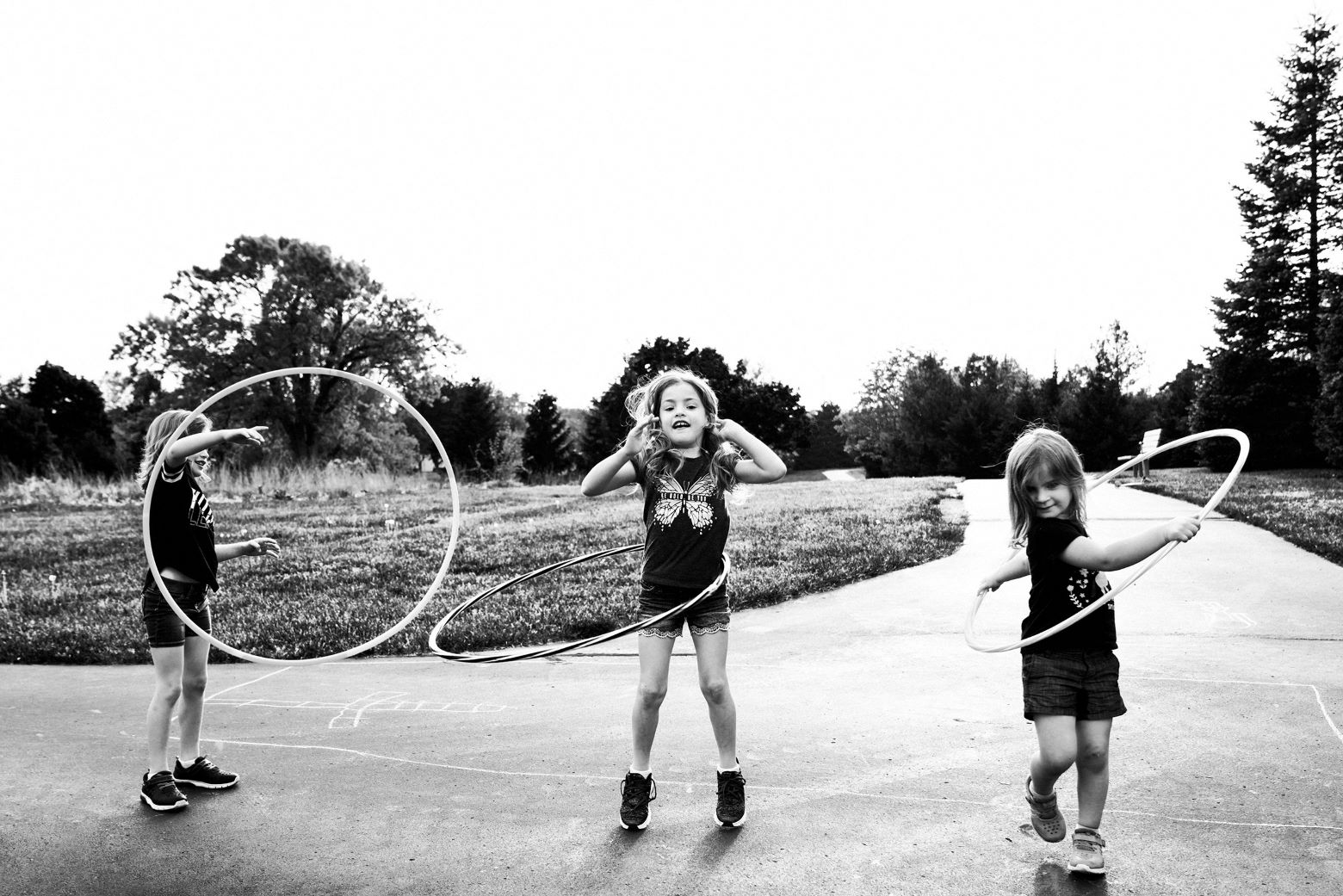 Three young girls hula-hooping