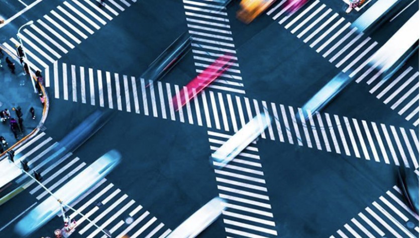 Photo of cars crossing a busy intersection