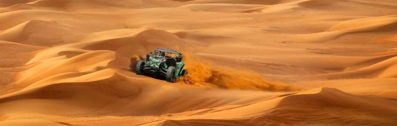 Dune buggy driving over undulating desert terrain