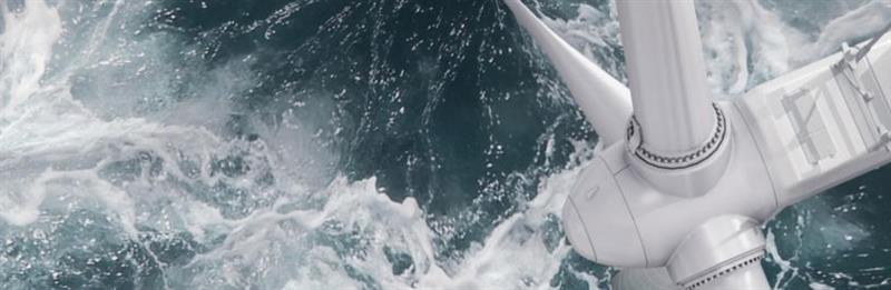 wind turbine blade rotating above ocean waves