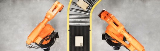 Overhead view of conveyor belts and robotic arms handling packages