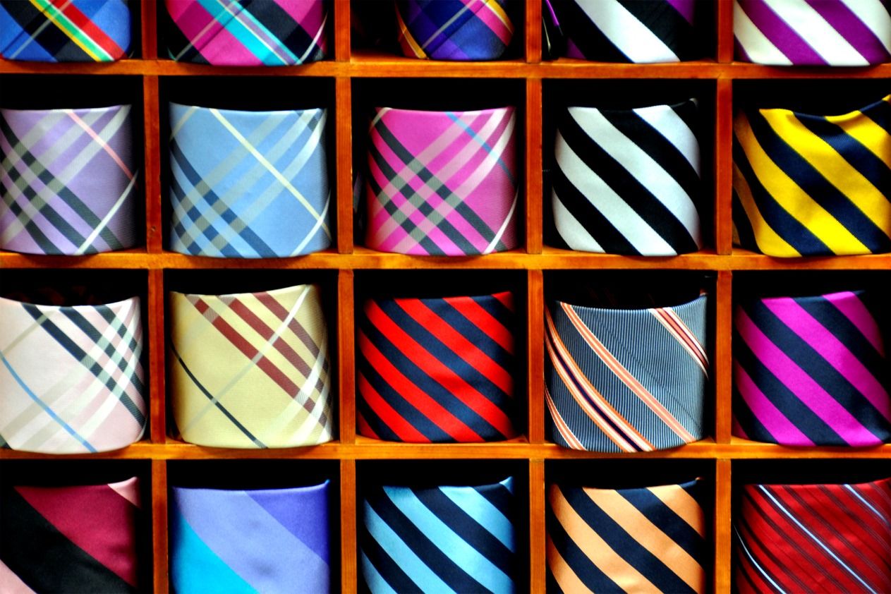 Image of colorful neckties in wooden display cubbies