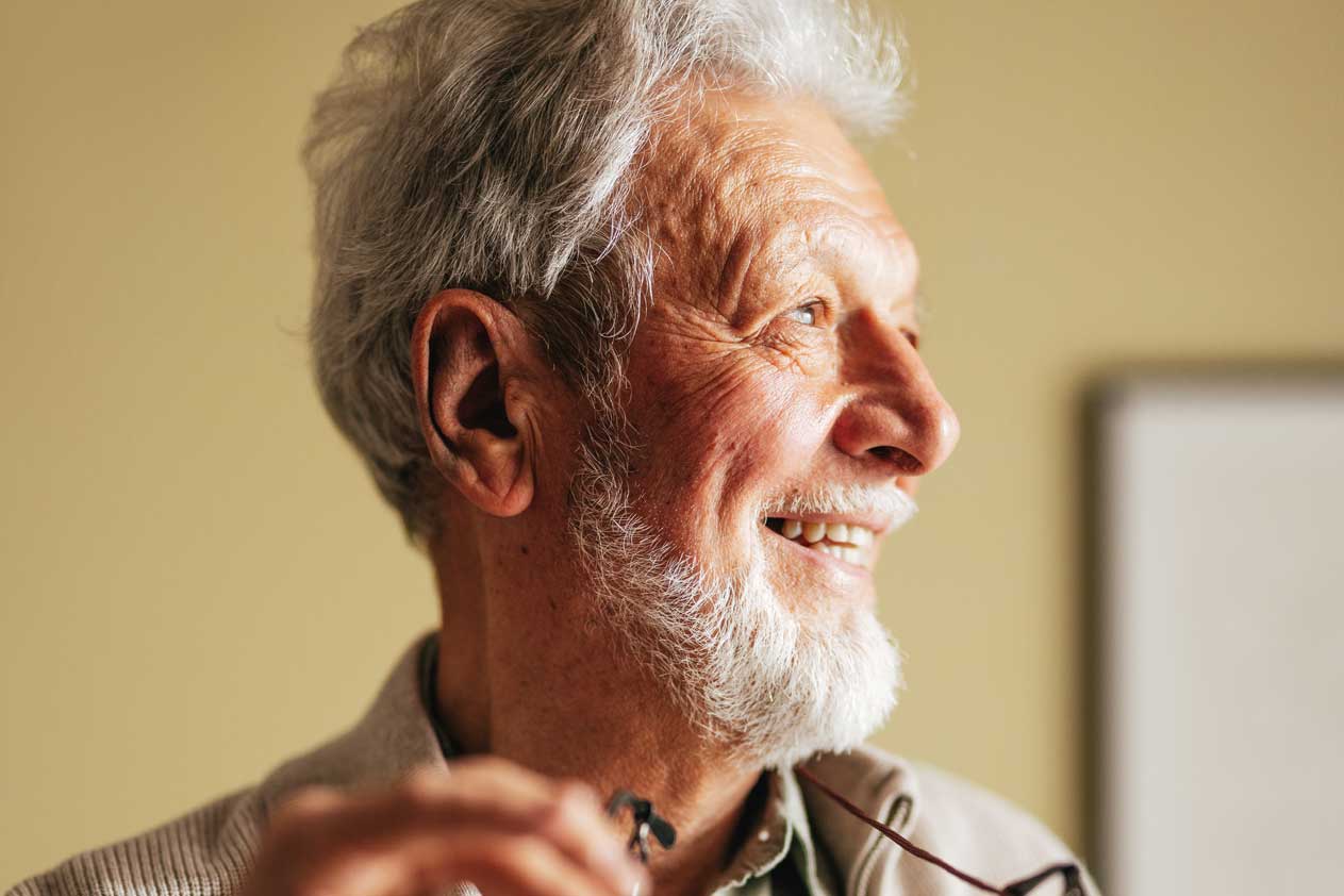 Image of person smiling and looking to the right