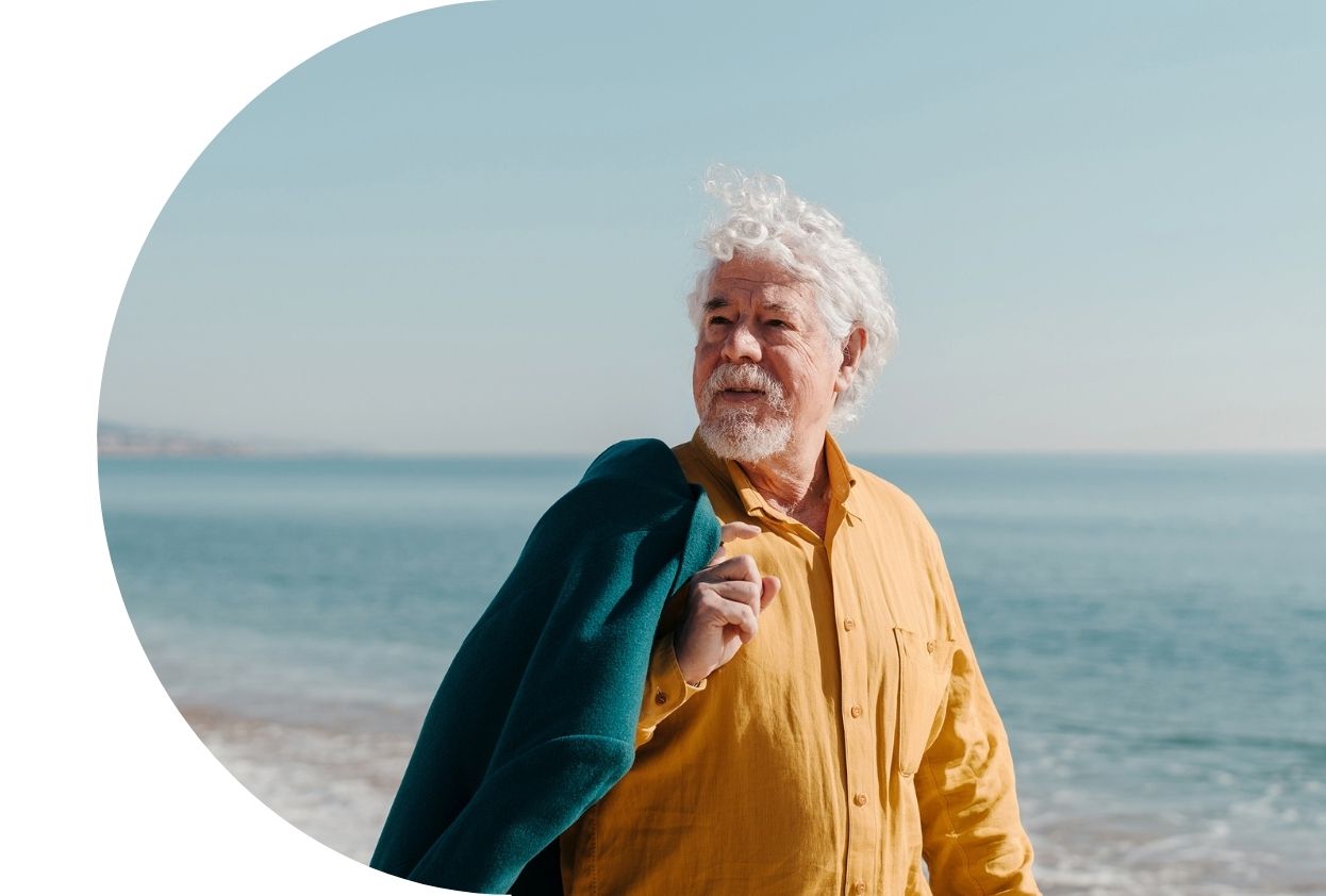 Old man walking along a beach