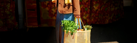 Lady with orange jacket with groceries