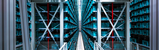 A view down the center aisle of a high-tech automated warehouse