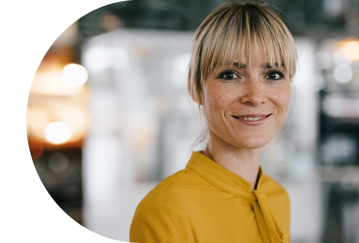 Blonde lady smiling in yellow shirt