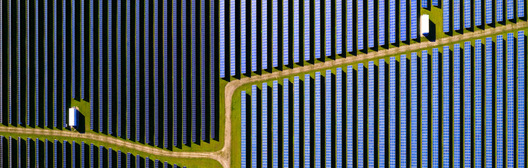 Rows of solar panels across a large solar energy facility