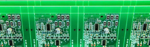 PCB manufacturing panel with repeated electronic circuit board designs and mounted components