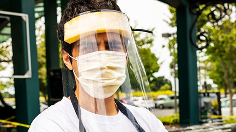 A man wearing a face shield and mask