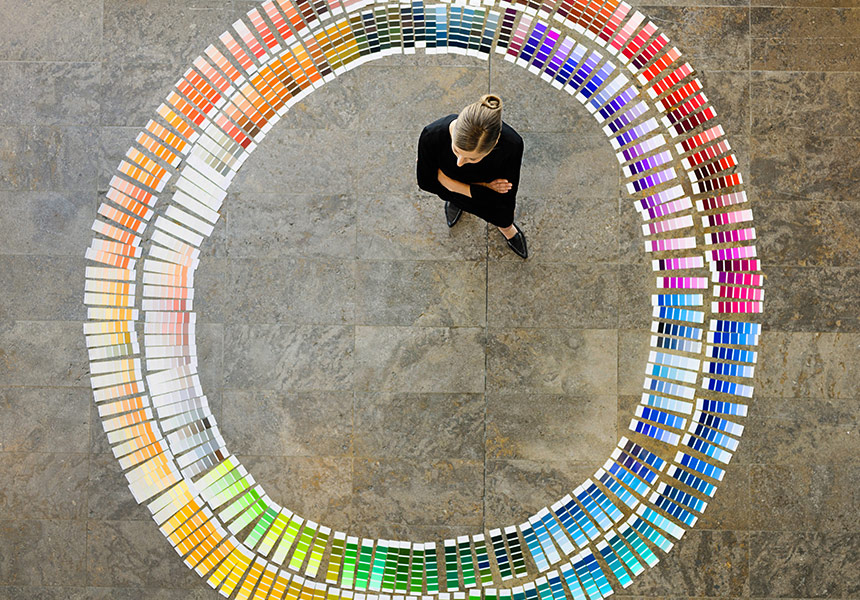 Woman standing with colour swatches surrrounding her