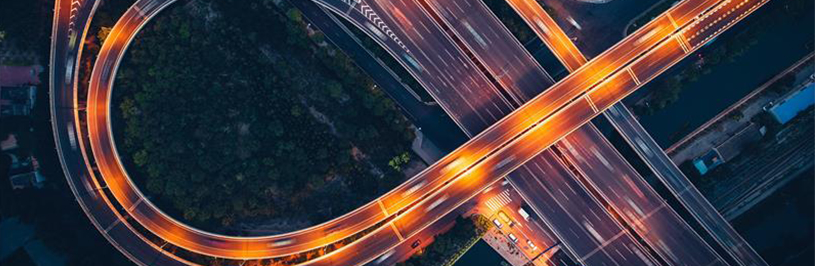Aerial view of a brightly lit highway interchange at night