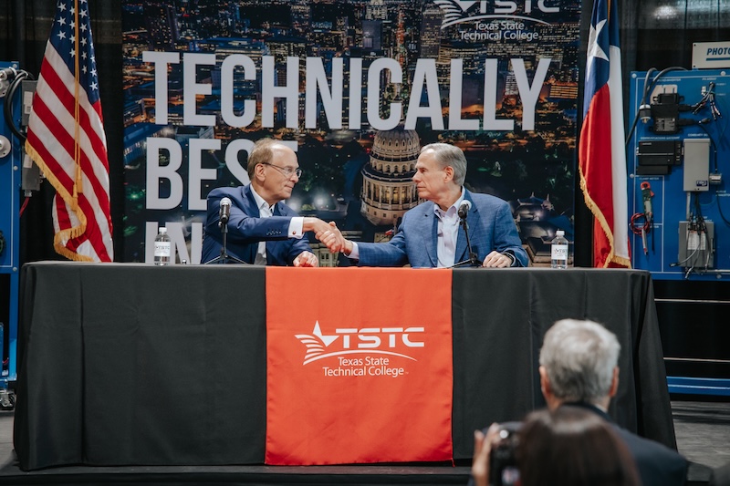 Larry Fink and Texas Governor, Greg Abbot, shaking hands at the Texas Future Builders event.
