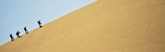 Group of friends climbing a mountain together