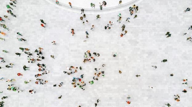 A group of people walking on a white surface