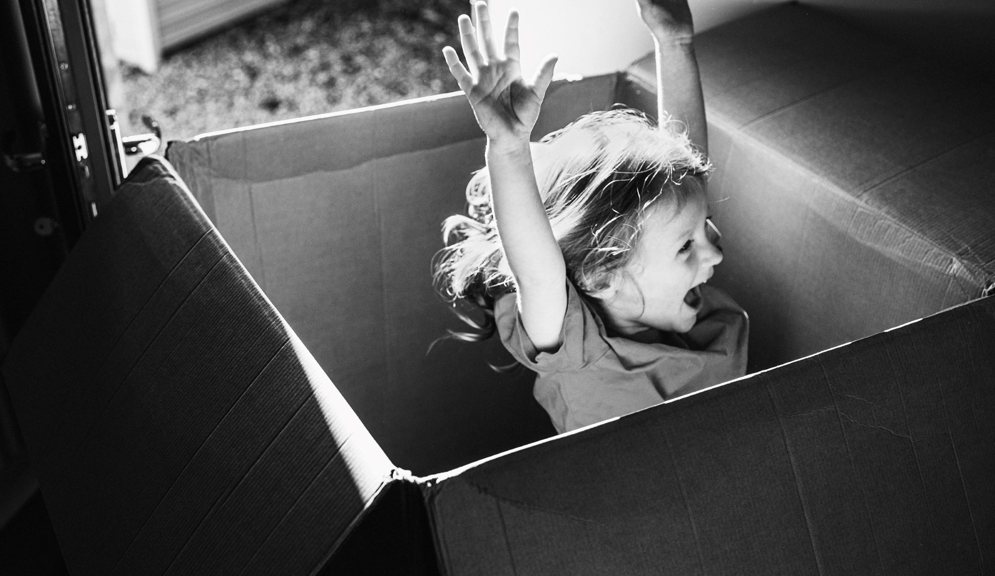 image of girl jumping out of box with joy