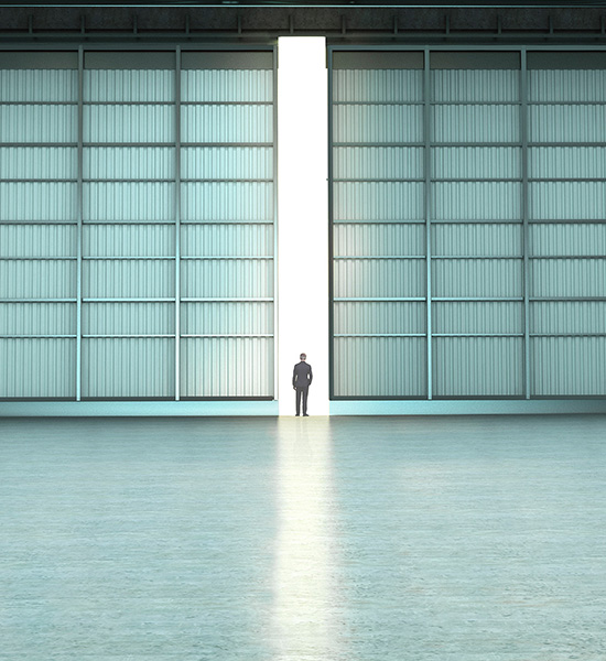 Image of a man standing in between the entry way of an door