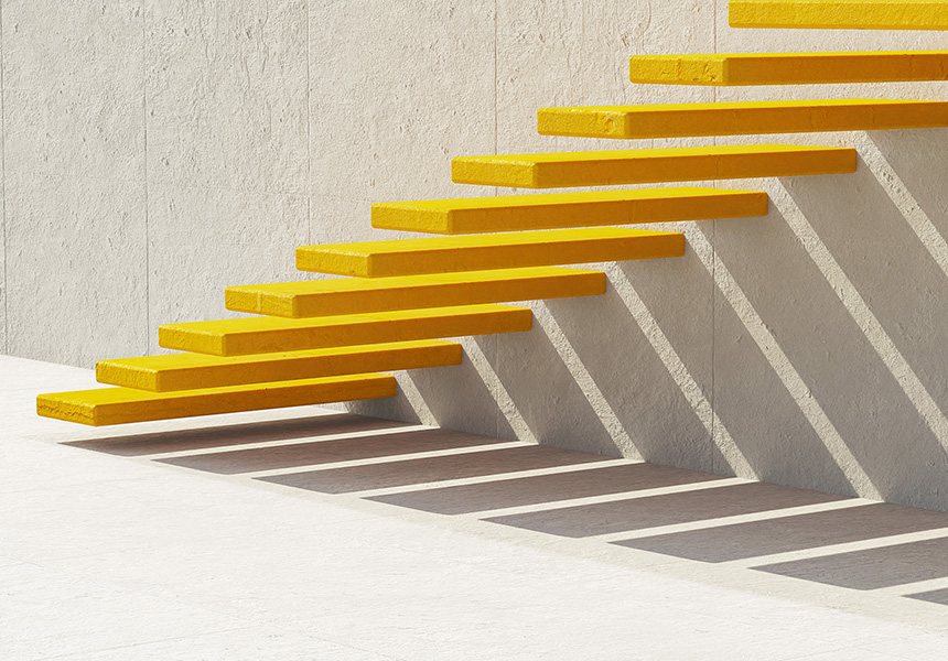 Yellow stairs in a white building, with shadows creating a striking contrast on the walls.