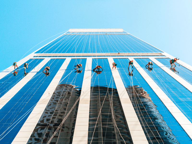image shows a woman in a swim suit and swim hat getting ready to jump into swimming pool