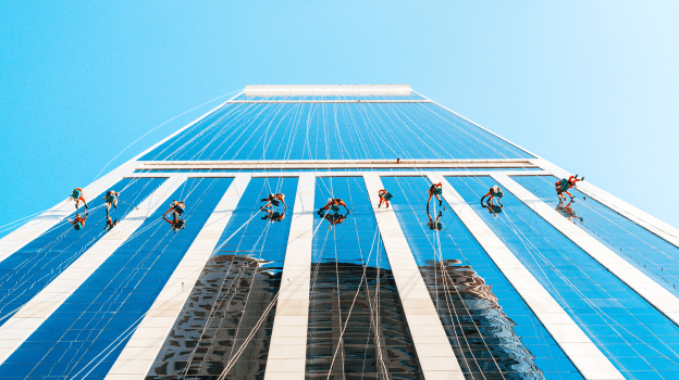 people rappelling down building