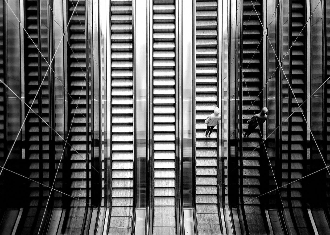 image of person going up an escalator