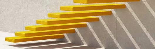 Minimalist yellow floating stairs mounted on a concrete wall, with strong sunlight creating geometric shadows.