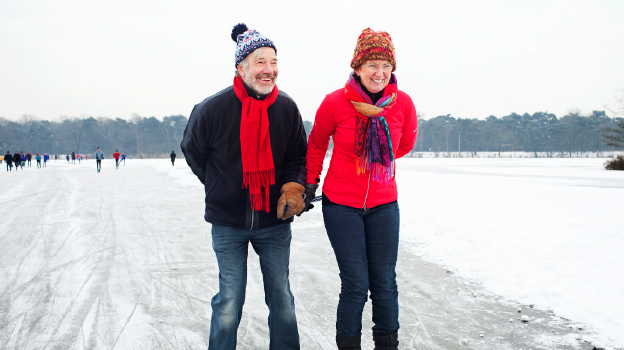 retired couple skating in snow