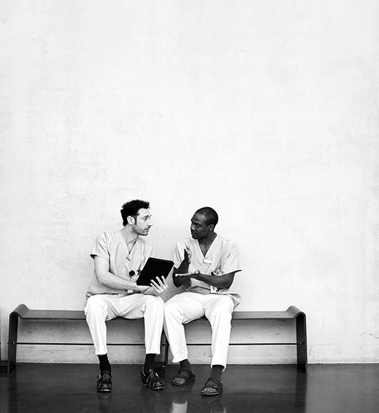 Two doctors talking while sitting on the bench