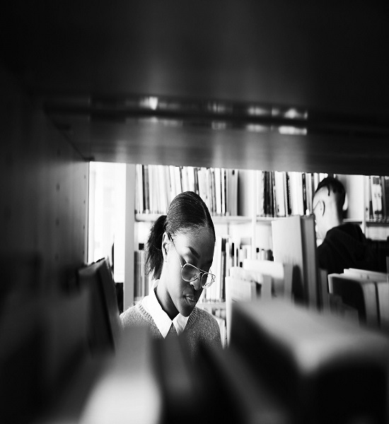 A woman reading book in a library