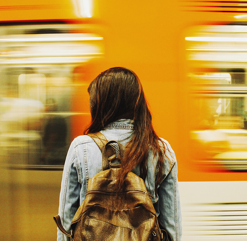 A woman watches a subway passing by