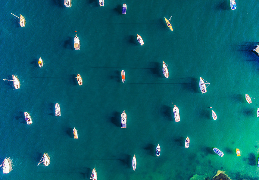 An overhead image of various personal boats in the water