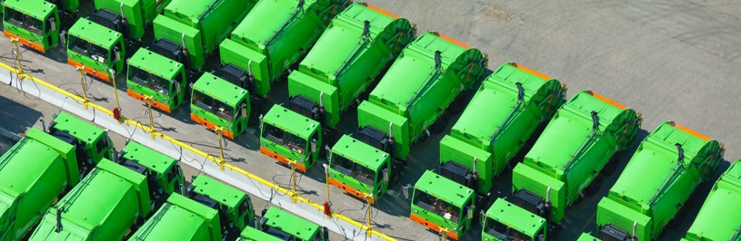 Green color trucks in a parking 
