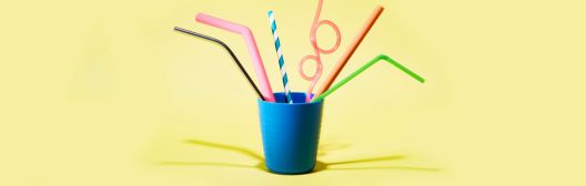 variety of straws arranged in a blue cup