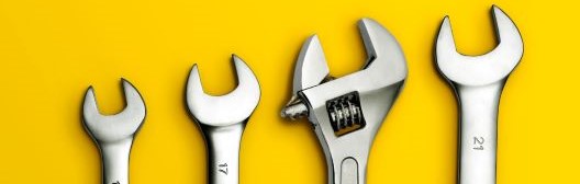 Wrenches on yellow background