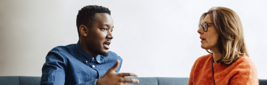 People conversing on couch