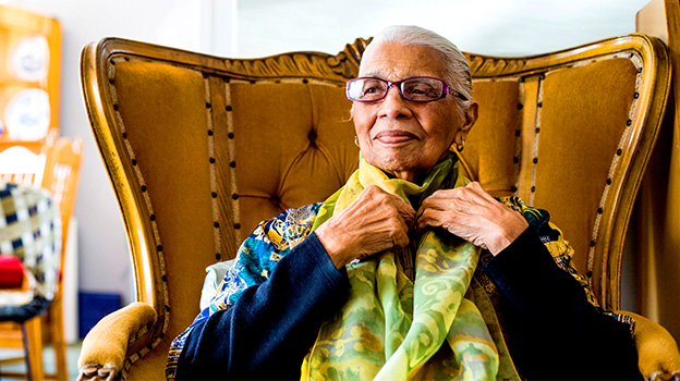 Woman sitting on a golden chair