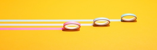 Image shows three rolls of electrical tape against yellow background