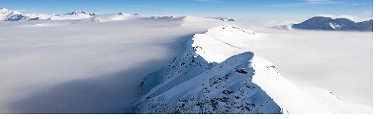 snow peaks above the clouds